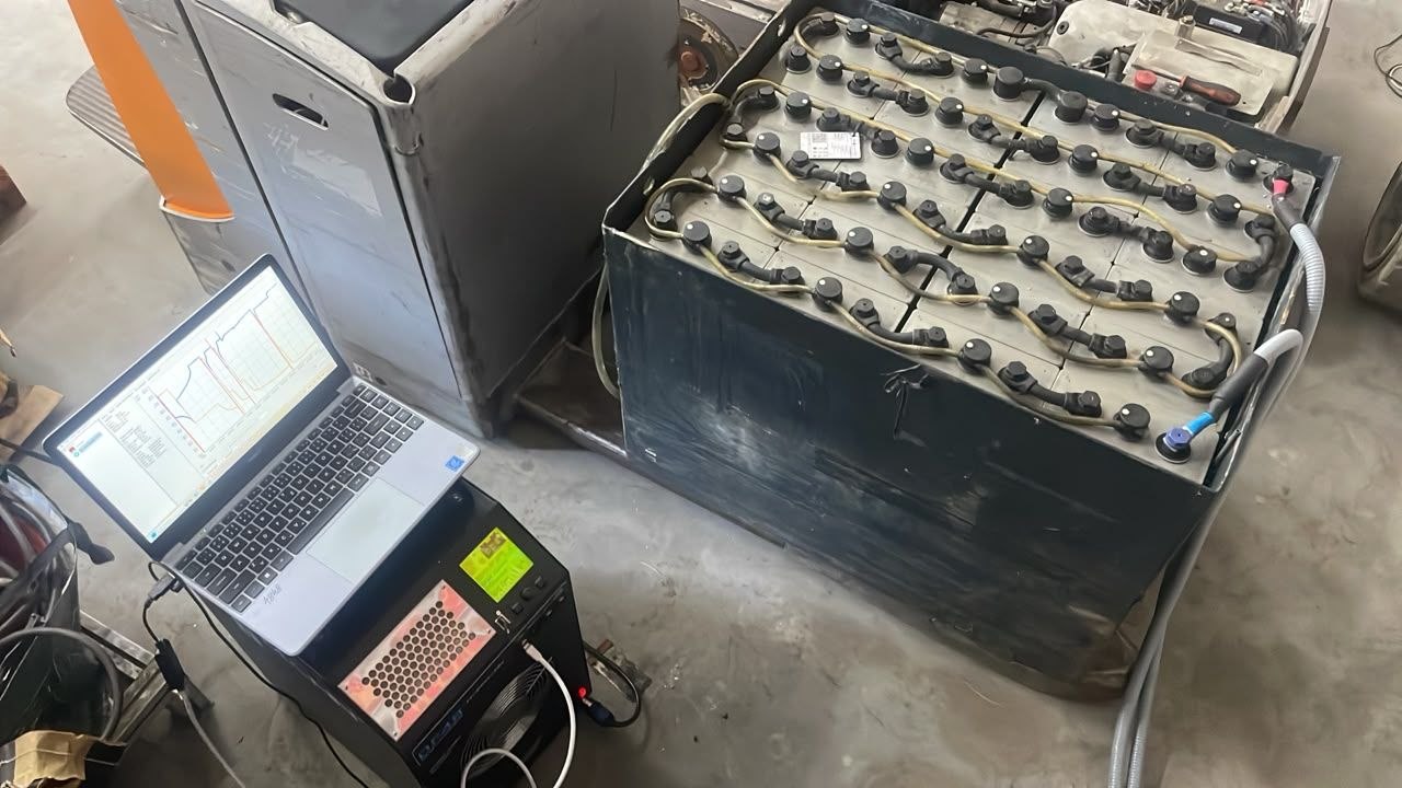 Forklift traction battery being regenerated on diagnostic equipment